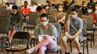 In this July 9, 2020, file photo, people wait to speak with representatives from the Oklahoma Employment Security Commission about unemployment claims in Midwest City, Okla.