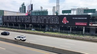 A banner that reads "Black Lives Matter" is seen on the wall at Fenway Park facing the Massachusetts Turnpike