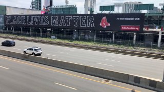 A banner that reads "Black Lives Matter" is seen on the wall at Fenway Park facing the Massachusetts Turnpike