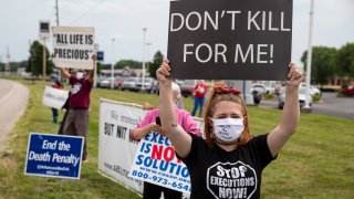 In this July 15, 2020, file photo, protesters against the death penalty gather in Terre Haute, Ind.