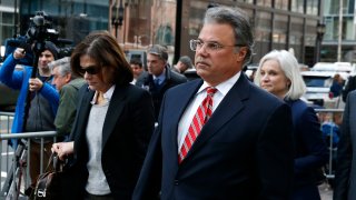 Manuel, right, and Elizabeth Henriquez leave the John Joseph Moakley United States Courthouse in Boston on April 3, 2019. 13 parents were scheduled to appear in federal court in Boston Wednesday for the first time since they were charged last month in a massive college admissions cheating scandal. They were among 50 people - including coaches, powerful financiers, and entrepreneurs - charged in a brazen plot in which wealthy parents allegedly schemed to bribe sports coaches at top colleges to admit their children. Many of the parents allegedly paid to have someone else take the SAT or ACT exams for their children or correct their answers, guaranteeing them high scores. (Photo by Jessica Rinaldi/The Boston Globe via Getty Images)