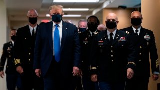 In this July 11, 2020, file photo, President Donald Trump wears a mask as he visits Walter Reed National Military Medical Center in Bethesda, Maryland.
