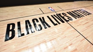 In this July 7, 2020, file photo, a general overall view of the court with Black Lives Matter messaging as part of the NBA Restart 2020 at The Arena at ESPN Wide World of Sports in Orlando, Florida.