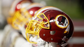 In this Nov. 23, 2014, file photo, Washington Redskins helmets sit on the sideline during their game against the San Francisco 49ers at Levi's Stadium in Santa Clara, California.