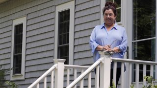 Poet Tammi Truax poses, Wednesday, July 29, 2020, on the front steps of her home in Eliot, Maine.