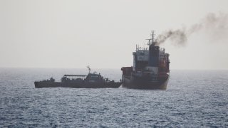In this Wednesday, Aug. 12, 2020 photo released by the U.S. Navy, the MT Wila is boarded by Iranian navy commandos in the Gulf of Oman off the eastern coast of the United Arab Emirates. The Iranian navy boarded and briefly seized a Liberian-flagged oil tanker near the strategic Strait of Hormuz amid heightened tensions between Tehran and the U.S., a U.S. military official said Thursday, Aug. 13, 2020.