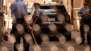 MINNEAPOLIS, MN - JUNE 13: Members of the Minneapolis Police Department seen through a chain link gate on June 13, 2020 in Minneapolis, Minnesota. The MPD has been under scrutiny from residents and local city officials after the death of George Floyd in police custody on May 25.
