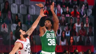 Marcus Smart #36 of the Boston Celtics shoots a three point basket during the game against the Toronto Raptors on August 7, 2020 at The Arena at ESPN Wide World Of Sports Complex in Orlando, Florida.