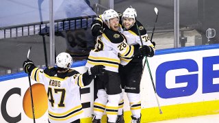 Jake DeBrusk #74 of the Boston Bruins is congratulated by his teammates after scoring a goal at 14:17 against the Carolina Hurricanes during the third period in Game Four of the Eastern Conference First Round during the 2020 NHL Stanley Cup Playoffs at Scotiabank Arena on August 17, 2020 in Toronto, Ontario.