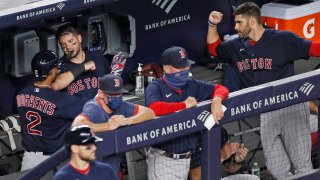 Boston Red Sox's Xander Bogaerts (2) celebrates with teammates in the dugout after hitting a fifth-inning solo home run in a baseball game against the New York Yankees, Sunday, Aug. 2, 2020, at Yankee Stadium in New York.