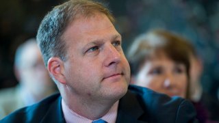 Chris Sununu listens during a State of New Hampshire Executive Council meeting at the Children's Museum of New Hampshire in Dover, N.H., Aug. 26, 2015.