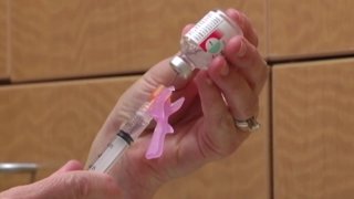 A flu shot is prepared at a local health care facility.