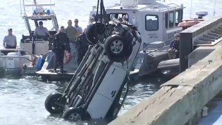 A white Ford Escape is pulled from Boston's Reserved Channel