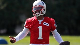 New England Patriots quarterback Cam Newton (1) holds the ball during an NFL football training camp practice, Friday, Aug. 21, 2020, in Foxborough, Mass. (AP Photo/Michael Dwyer, Pool)
