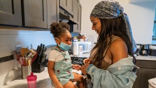 Kathering Guzman, right, gets her sister Jazzmyn ready to go out for ice cream