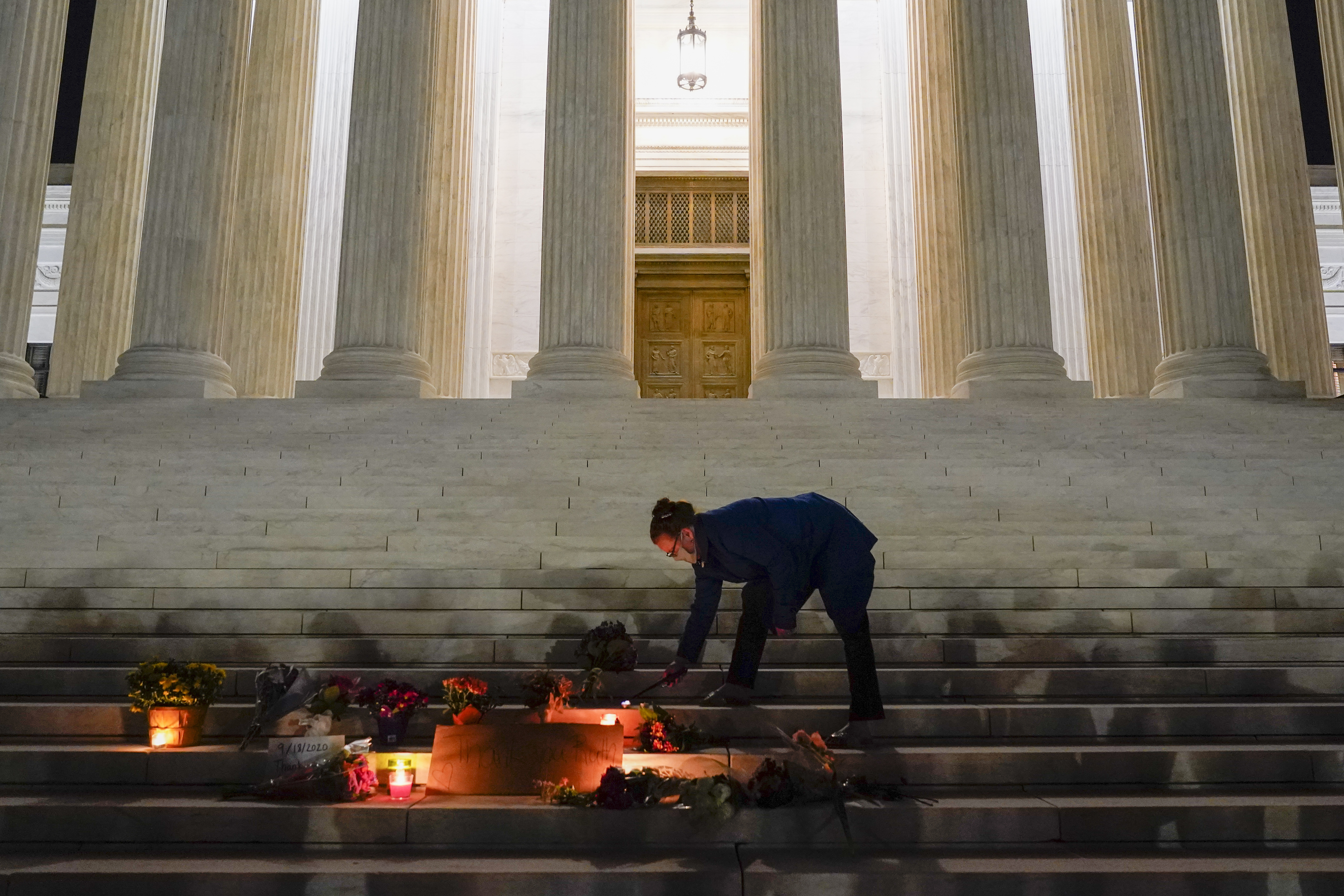 People lay flowers outside the Supreme Court Friday, Sept. 18, 2020, in Washington, D.C.