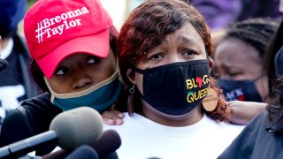 Tamika Palmer, the mother of Breonna Taylor, right, listens to a news conference