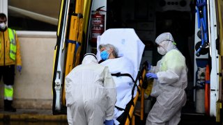 Members of the medical staff of the Summa, Medical Emergency Service of Madrid, transfer a patient in a stretcher at the 12 de Octubre hospital.