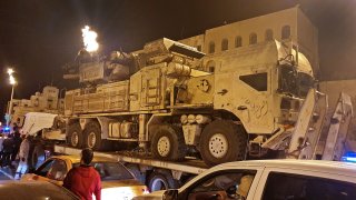 Forces loyal to Libya's UN-recognised Government of National Accord (GNA) parade a Russian-made Pantsir air defense system truck in the capital Tripoli on May 20, 2020, after its capture at al-Watiya airbase (Okba Ibn Nafa airbase) from forces loyal to Libya's eastern-based strongman Khalifa Haftar. - Libya's UN-recognised government scored another battlefield victory on May 18 against strongman Khalifa Haftar, capturing the key rear base used by his fighters in a conflict now in its second year. Haftar, who controls swathes of eastern Libya, launched an offensive in April last year against the capital Tripoli, seat of the UN-recognised Government of National Accord (GNA).