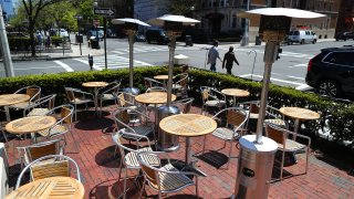 This May 15, 2020, file photo shows outdoor tables and chairs at Cafeteria Restaurant on Newbury Street in Boston.