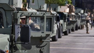 BOSTON, MA – JUNE 8: The Massachusetts National Guard heads out of a parking lot near South Station in Boston on June 8, 2020. National Guard were deployed in Boston to keep order during a series of protests regarding the killing of George Floyd and police brutality. After some protests, late-night looting and vandalism occurred. (Photo by Stan Grossfeld/The Boston Globe via Getty Images)