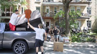 A group of people unload household items from a truck in Montreal, Quebec, Canada, on Wednesday, July 1, 2020. On the city's traditional moving day, local companies are trying to make up for some of the income lost during the Covid-19 shutdown with a big July 1 push, CTV News reports.