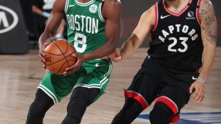 The Boston Celtics' Kemba Walker holds the ball in a playoff game against the Toronto Raptors