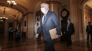 In this Sept. 30, 2020, file photo, Senate Majority Leader Mitch McConnell, a Republican from Kentucky, wears a protective mask while walking to the senate floor as Amy Coney Barrett, U.S. President Donald Trump's nominee for associate justice of the U.S. Supreme Court, not pictured meets with senators at the U.S. Capitol in Washington, D.C.