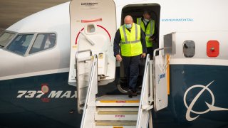 Steve Dickson, administrator of the Federal Aviation Administration (FAA), wears a protective mask while exiting a Boeing Co. 737 Max airplane after a test flight in Seattle, Washington, U.S., on Wednesday, Sept. 30, 2020. Dickson, who is licensed to fly the 737 along with several other jetliners from his time as a pilot at Delta Air Lines Inc., will be at the controls of a Max that has been updated with a variety of fixes the agency has proposed and may soon make mandatory.