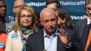 Gun violence victim and former U.S. Congresswoman Gabby Giffords watches her husband, NASA astronaut Mark Kelly, speak as they visits City Hall on her 2016 Vocal Majority Tour on October 17, 2016 in New York City. Giffords and Kelly are on a six-week, nationwide bus tour to battleground states asking people to vote for candidates who support gun violence prevention legislation in this coming November election. The Vocal Majority Tour is a project of their national organization, Americans for Responsible Solutions PAC. Giffords, who has made a dramatic recovery, survived an assassination attempt in 2011 near Tucson, Arizona.