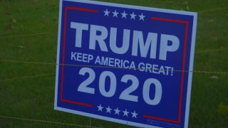 A Trump 2020 sign surrounded by electrified wire in a New Bedford, Massachusetts, yard.