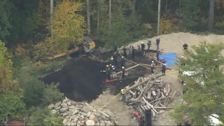 A rescue operation after an excavator rolled over in Sutton, Massachusetts