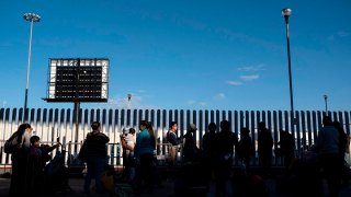 Asylum seekers wait for their turn to cross to the U.S. at El Chaparral crossing port on the U.S.-Mexico Border in Tijuana, Baja California state, Mexico, Feb. 29, 2020.