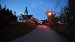 A road is illuminated by a street light on Thursday April 28, 2016 in Islesford, ME. Islesford is located on Little Cranberry Island, which is home to many lobstermen.