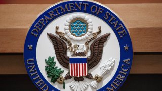 The U.S. Department of State seal is seen on the podium-lectern area, Nov. 26, 2013, in the State Department briefing room in Washington, D.C.