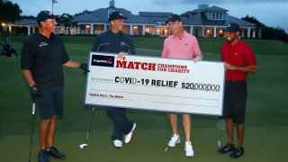 Tiger Woods and former NFL player Peyton Manning celebrate defeating Phil Mickelson and NFL player Tom Brady of the Tampa Bay Buccaneers on the 18th green during The Match: Champions For Charity at Medalist Golf Club on May 24, 2020 in Hobe Sound, Florida.