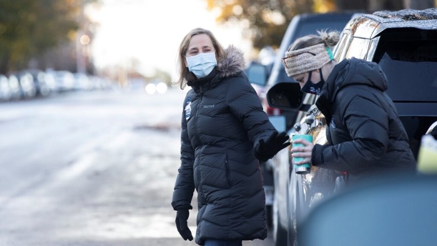 Mayor of Manchester, NH, Joyce Craig walks towards the Webster School after a media interview.