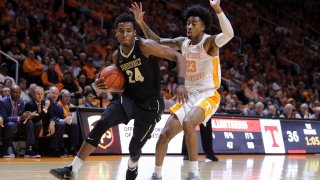 Aaron Nesmith #24 of the Vanderbilt Commodores drives with the ball past Jordan Bowden #23 of the Tennessee Volunteers during the first half of their game at Thompson-Boling Arena on February 19, 2019 in Knoxville, Tennessee.