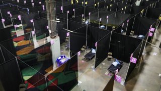 WORCESTER, MA – APRIL 7: Makeshift hospital rooms fill the floor in the first field hospital in the state of Massachusetts at the DCU Center in downtown Worcester, MA on Apr. 7, 2020 as the state prepares for an expected surge in coronavirus patients. UMass Memorial Health Care will operate the pop-up hospital, which is the first one of three that the state is planning to open. The facility is expected to open Thursday, April 9. (Photo by Erin Clark for The Boston Globe via Getty Images)