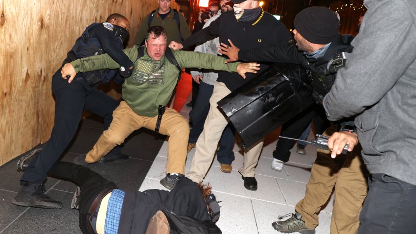 A police officer tries to break up a fight between Black Lives Matter protesters and members of the Proud Boys during a protest following the “Million MAGA March” from Freedom Plaza to the Supreme Court, on November 14, 2020 in Washington, DC. Supporters of U.S. President Donald Trump gathered to protest the outcome of the 2020 presidential election. (Photo by Tasos Katopodis/Getty Images)