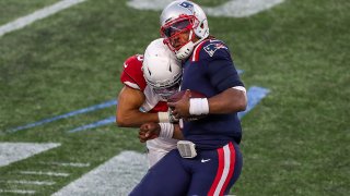 Nov 29, 2020; Foxborough, Massachusetts, USA; New England Patriots quarterback Cam Newton (1) is tackled by Arizona Cardinals linebacker Isaiah Simmons (48) during the second half at Gillette Stadium. Mandatory Credit: Paul Rutherford-USA TODAY Sports
