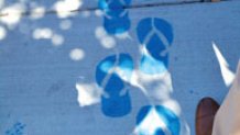 The blue stencil of sandals along the Urban Trail.