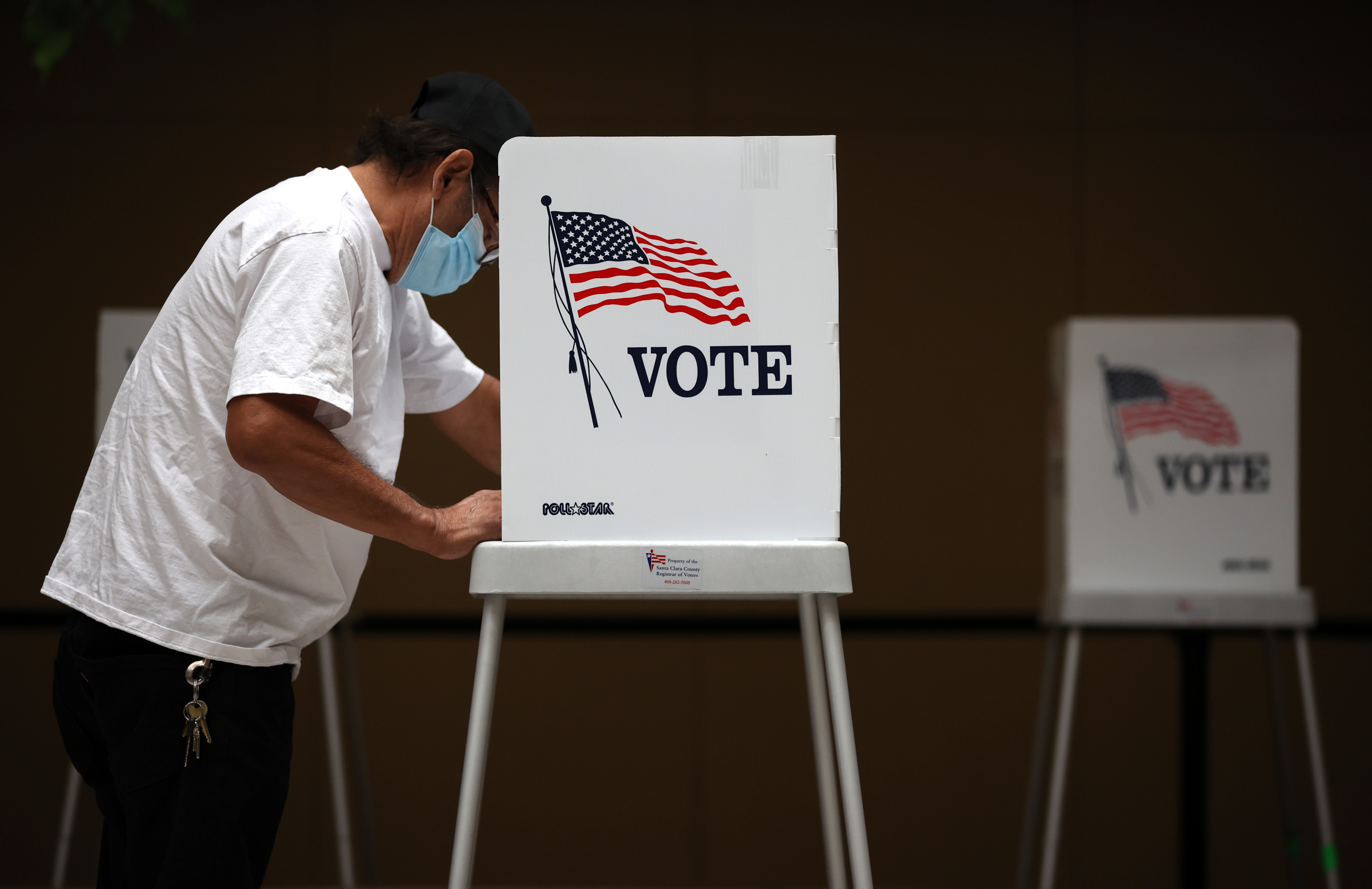 In this Oct. 13, 2020, file photo, a voter fills out his ballot while early voting at the Santa Clara County registrar of voters office in San Jose, California.
