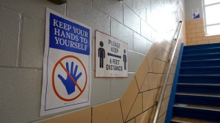 CHICAGO, ILLINOIS – SEPTEMBER 08: Signs in a stairway at King Elementary School encourage social distancing as the school works to maintain a safe environment during the coronavirus pandemic on September 08, 2020 in Chicago, Illinois. Students at King Elementary and the rest of Chicago public schools started classes today remotely because of COVID-19 concerns. Teachers have the option of teaching from home or from their classrooms.  (Photo by Scott Olson/Getty Images)