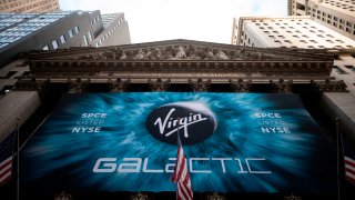 GP: A logo of a Virgin Galactic is seen outside the building during the company’s first day of trading on the New York Stock Exchange (NYSE) on October 28, 2019 in New York City.
