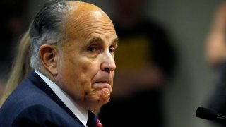 In this Dec. 2, 2020, file photo, Rudy Giuliani, personal lawyer of US President Donald Trump, looks on during an appearance before the Michigan House Oversight Committee in Lansing, Michigan.