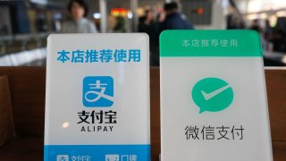 Alipay and WeChat Pay logos for online payment are displayed at a store on November 9, 2019 in Changzhou, Jiangsu Province of China. Ant Group which runs Alipay and Tencent which runs WeChat Pay, are the two dominant players in China’s mobile payments space. But both companies offer other financial services. Regulators are keeping a closer eye on the fintech industry in China.