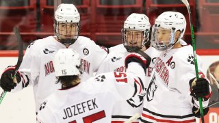 Northeastern Huskies players celebrate scoring