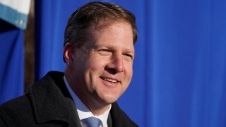 New Hampshire Governor Chris Sununu addresses a gathering outside the Elliot Hospital, Tuesday, Dec. 15, 2020, in Manchester, New Hampshire.