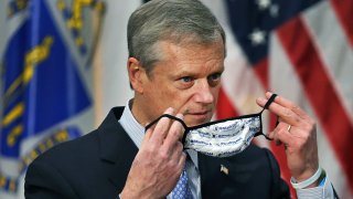 Massachusetts Gov. Charlie Baker is pictured with his mask (which promotes #MaskUpMA) during a news conference at the State House concerning the upcoming Christmas holiday as it relates to the COVID-19 pandemic on Monday, Dec. 21, 2020.